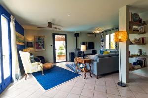 a living room with a couch and a table at La Maison Bleue in Rustrel +43 photos