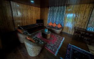 an overhead view of a living room with chairs and a table at Pine Haven Resorts in Takdāh