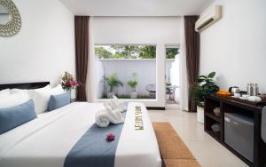 a bedroom with a bed with a stuffed animal on it at Serenity Boutique in Siem Reap +96 photos