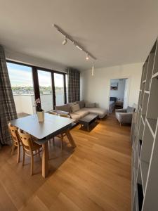 a living room with a table and a couch at Grunwaldzka 62 in Bydgoszcz +14 photos
