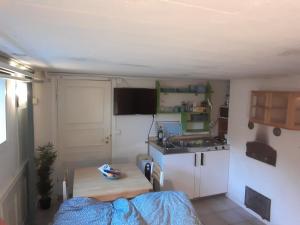a small kitchen with a table and a sink at Sundqvistens basement in Emkarby