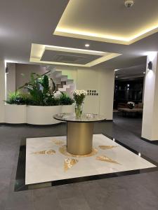 a lobby with a table with flowers on it at Göcek Lykia Resort Premium Concept Hotel in Göcek +40 photos