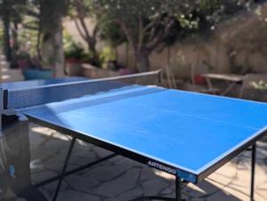 a blue ping pong racket on top of a table at Le Jasmin in Mauguio