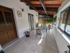 a dining room with a table and chairs and a door at Le Jasmin in Mauguio