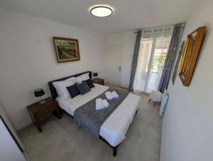 a bedroom with a bed with two towels on it at Le Jasmin in Mauguio +31 photos