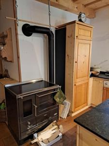 a kitchen with an old stove in a room at Hüthis Waldidylle in Dambach +7 photos