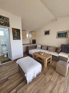 a living room with a couch and a table at Holiday home Ramovic in Virpazar