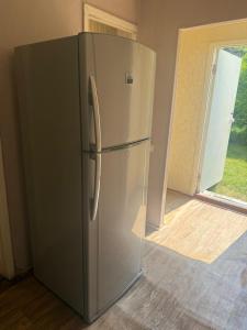 a stainless steel refrigerator in a room with a window at Guest house at the Lake Sevan in Sevan +19 photos