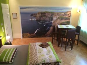 a room with a dining table and a painting of the ocean at Park Villa Gernsheim in Gernsheim