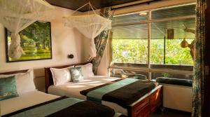 a bedroom with two beds and a window at Ella green stay in Ella