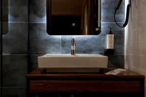 a bathroom with a white sink and a mirror at Borjomind Hotel Borjomi in Borjomi +92 photos