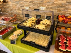 a buffet with cheese and other foods on a table at Villa Corte Degli Dei in Lucca