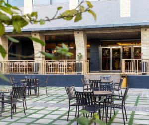 a group of tables and chairs in front of a building at Grand Palace Hotel Lusaka in Lusaka