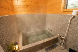 a bathroom with a tub in a room at Mtd大分天ヶ瀬 in Hita +47 photos