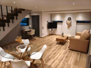 a living room with a couch and a table at Aura Mare in Porto Rafti