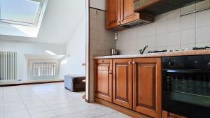 a kitchen with a sink and a stove at Levico Old Town Loft in Levico Terme