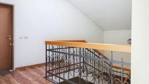 a room with a staircase with a railing and a room withoren at Levico Old Town Loft in Levico Terme