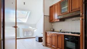 a kitchen with a sink and a stove top oven at Levico Old Town Loft in Levico Terme