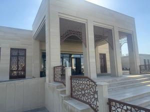 a building with stairs and arches on a building at Imam Bukhari Grand Hotel in Khodzha-Ismail