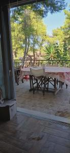 a patio with a table and a picnic table at Agios Stefanos TwoStory Maisonette in Néa Zoryiáni