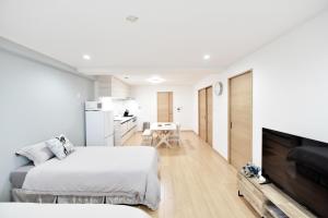 a bedroom with two beds and a flat screen tv at Room 501 Japanese Tatami 3LDK 75sqm Near Namba Family Friendly Stay in Osaka