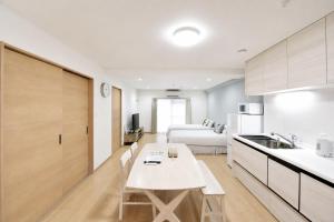a kitchen and living room with a table and a bed at Room 501 Japanese Tatami 3LDK 75sqm Near Namba Family Friendly Stay in Osaka