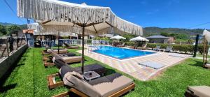 a swimming pool with chaise lounges and a swimming pool at House Michalis in Sarti
