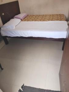 a bed in a room with a white floor at Royal Residency in Gingee