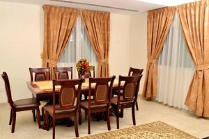 a dining room with a table and chairs at Sara Hotel Apartments in Ajman 