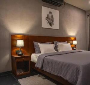 a bedroom with a bed with a wooden head board at Viento - Habarana in Habarana