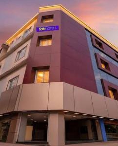a building with a purple sign on top of it at Embassy Gate Residency - opp US Embassy in Chennai