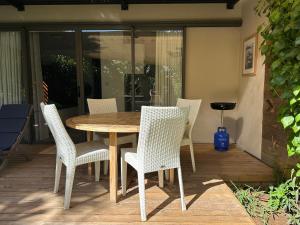 a wooden table and chairs on a patio at Cosy Studio 71 in Petite Case Noyale