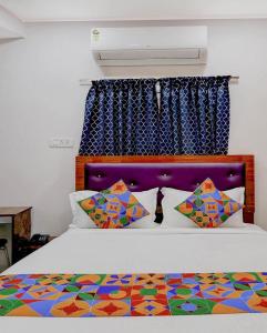 a bedroom with a bed with a colorful comforter at Embassy Gate Residency - opp US Embassy in Chennai