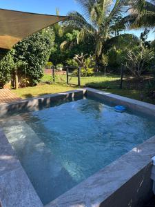 a swimming pool with blue water in a yard at Cosy Studio 71 in Petite Case Noyale