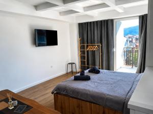 a bedroom with a bed and a large window at Luxury Apartment Poli in Ohrid