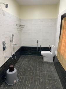 a bathroom with a toilet and a shower in it at SSR PARADISE ROOMs in Kavarapettai