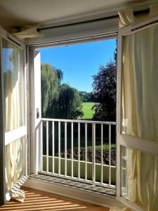 a window with a view of a golf course at Natura2000 in Châteauroux