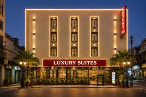 a hotel building with a sign that reads luxury suites at Hotel Luxury Stay Igi Airport Delhi in New Delhi