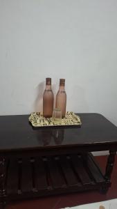 two brown bottles sitting on top of a table at Umbrella Guest House - Palace Suite in Madurai