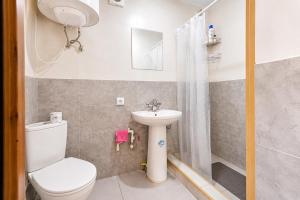 a small bathroom with a toilet and a sink at Ushguli Cabins l Cafe in Ushguli