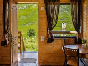 a dining room with a table and a window at Ushguli Cabins l Cafe in Ushguli