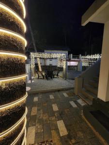 a house with a patio at night with lights at Seabay Bliss Varkala by Ojes in Varkala