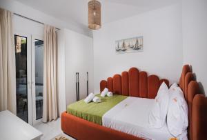 a bedroom with a large bed with a red headboard at Moonlit Villa in Planos +21 photos