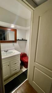 a bathroom with a sink and a red toilet at Luxury KIA Room K in Richmond Hill +24 photos
