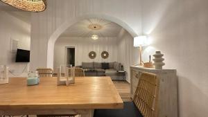 a living room with a wooden table and a couch at La maison - Two Private Apartments, One with Private Pool in Angairiá