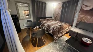 a bedroom with a bed and a table and a couch at Luxury KIA Room K in Richmond Hill