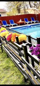 a bench with flowers on it next to a swimming pool at Luxury KIA Room K in Richmond Hill