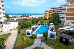 an apartment with a swimming pool and a view of the beach at Hotel Ambasador Mamaia in Mamaia