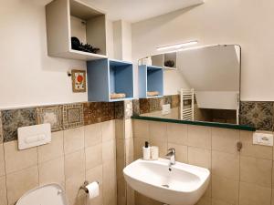 a bathroom with a sink and a mirror at B&B Interno SG in LʼAquila +14 photos