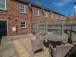 a patio with a table and chairs and a fence at 3 Railway Terrace in Bridlington